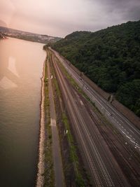 High angle view of road amidst trees against sky