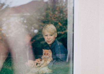 Boy looking away in a window