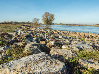 Rocks by sea against sky