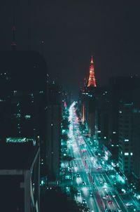 High angle view of city lit up at night