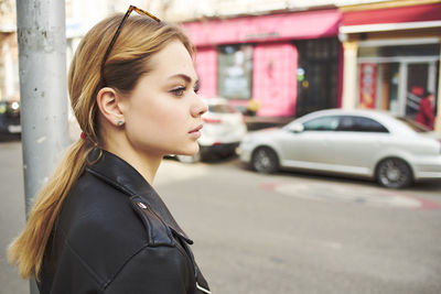 Young woman looking away in city