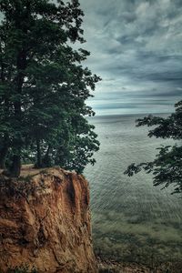 Scenic view of rocks in sea against sky