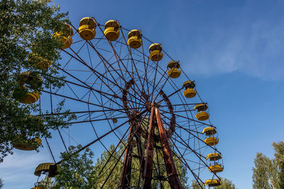 Low angle view of ferris wheel against sky