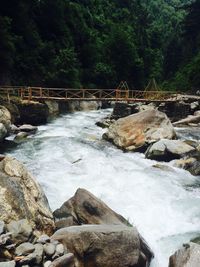 Scenic view of river flowing through rocks