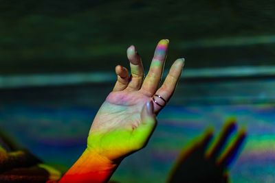 Cropped hand with colorful lights