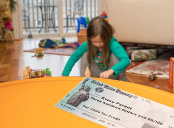 Portrait of girl holding table