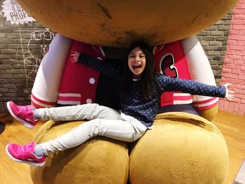 Full length portrait of happy girl playing
