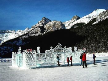 Tourists on snow covered mountain