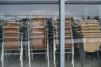 Stacked chairs seen through window