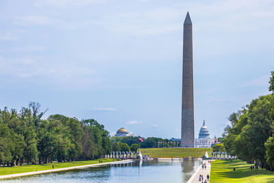 View of monument in lake against sky