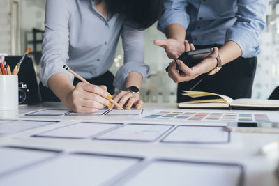 Low section of people working on table