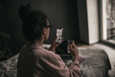 Side view of mature man drinking glass