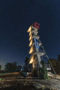 Low angle view of illuminated building against sky at night