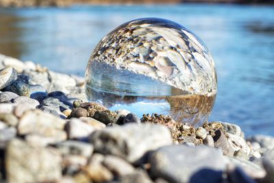 Close-up of stones on beach in lensball