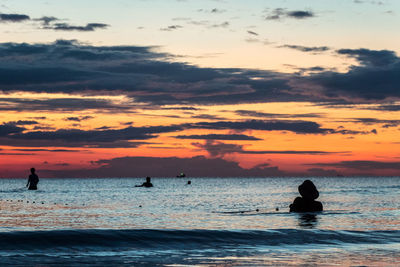 A fisherman is fishing at sunset on koh rong, cambodia