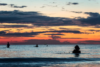 A fisherman is fishing at sunset on koh rong, cambodia
