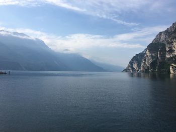 Scenic view of sea and mountains against sky