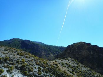 Scenic view of mountains against clear blue sky