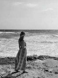 Woman on beach against sky