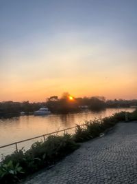 Scenic view of river against sky during sunset