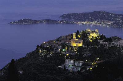 Aerial view of city lit up at night