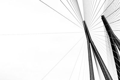 Low angle view of suspension bridge against sky