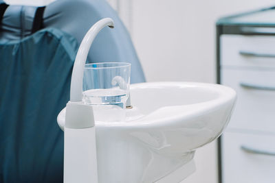 Midsection of woman washing hands in bathroom