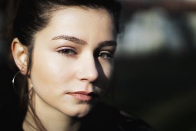 Close-up portrait of beautiful young woman outdoors