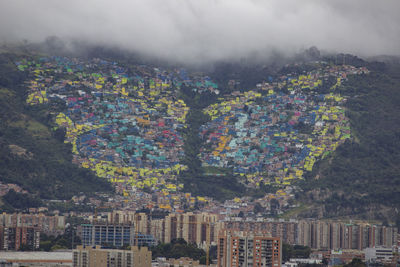 High angle view of rainbow over buildings in city