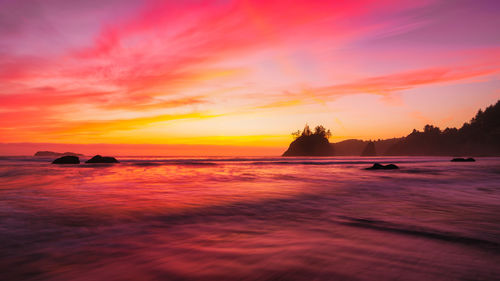 Scenic view of sea against orange sky