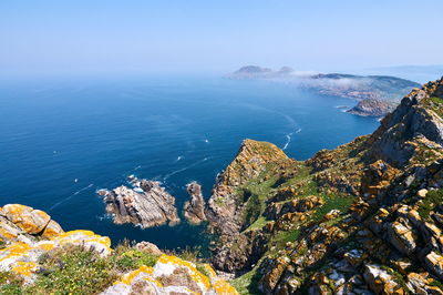 High angle view of rocks by sea against sky