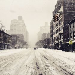 Road along buildings in city