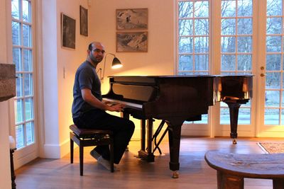 Portrait of man playing grand piano