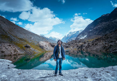 Portrait of man standing on mountain against sky