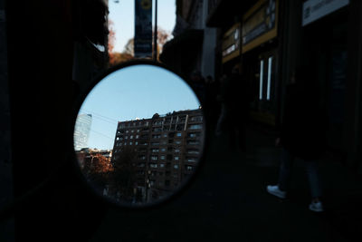 Reflection of man in city