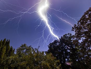 Low angle view of lightning in sky at night