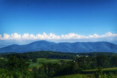 Scenic view of landscape against cloudy sky