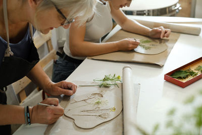 Pottery workshop in studio. master working with clay on the table. adults learning to do ceramic