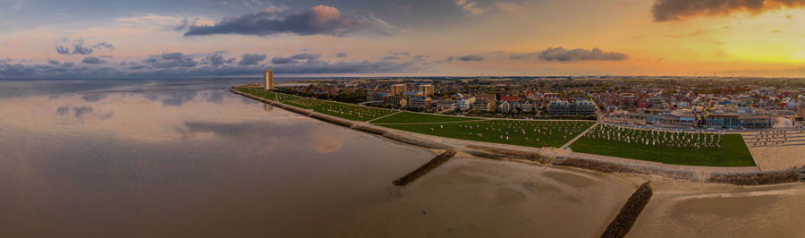 High angle view of river and cityscape against sky during sunset