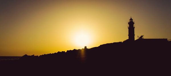 Silhouette of statue at sunset