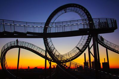 Low angle view of silhouette bridge against sky during sunset