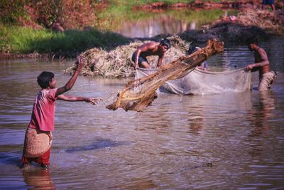 Full length of man standing in river