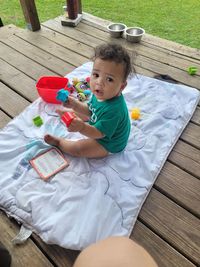 High angle view of cute baby boy sitting on table