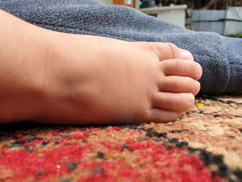 Close-up of woman hand on floor