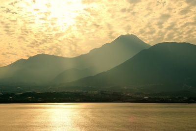 Scenic view of mountains against cloudy sky