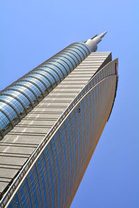 Low angle view of skyscraper against clear blue sky