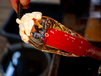 Close-up of hand holding glass bottle