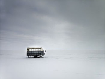 Icefishing hut on frozen lake