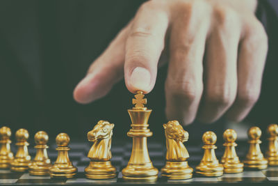 Low angle view of hand of chess pieces