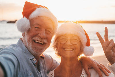 Portrait of senior couple holding hands at beach